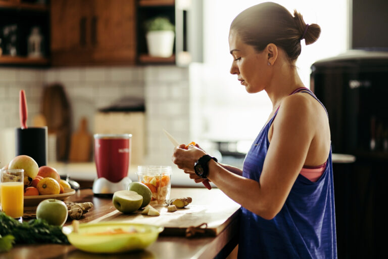 Athletic woman slicing fruit