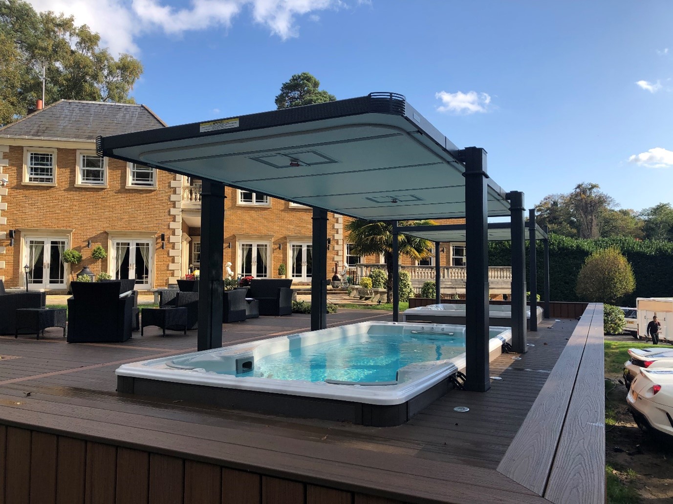 Modern outdoor swim spa installation with an automatic cover.